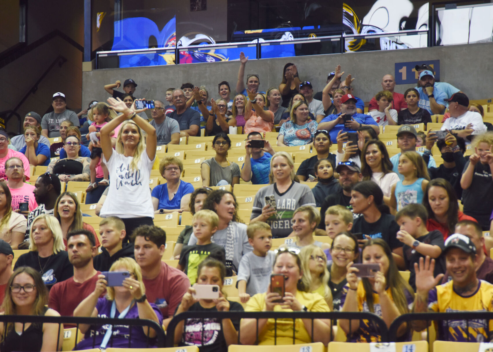 Family and friends cheer as the athletes enter the arena